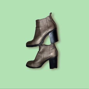 A silver-gold-ish Ankle Platform Heeled Booties